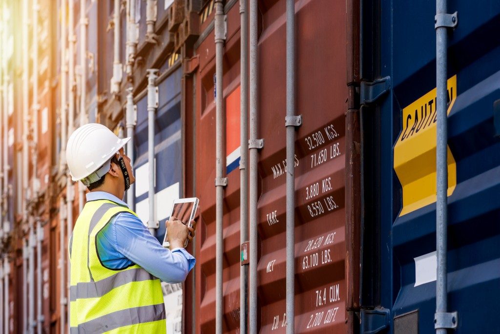 Man monitoring cargo freight ships