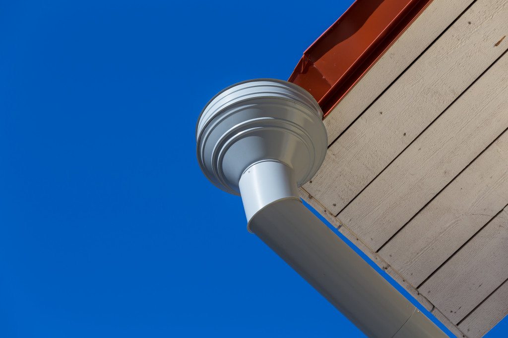 Rain gutter on house with blue sky in the background