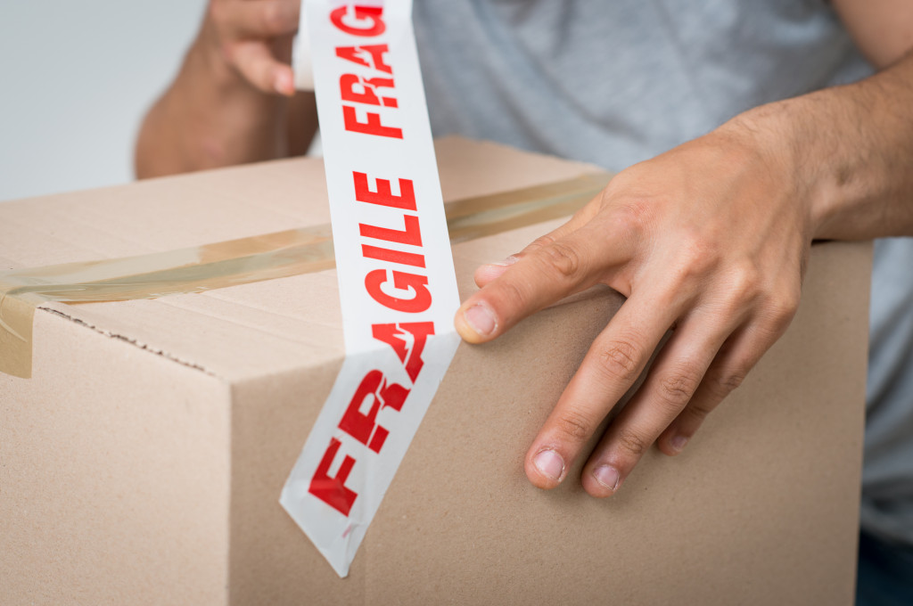 man marking the box as fragile