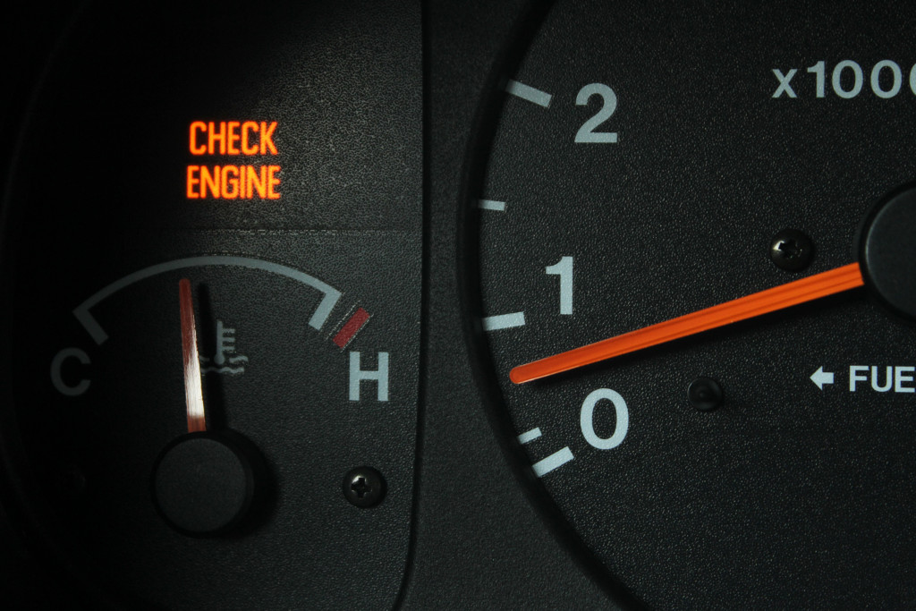 The check engine indicator lighting up on a car dashboard